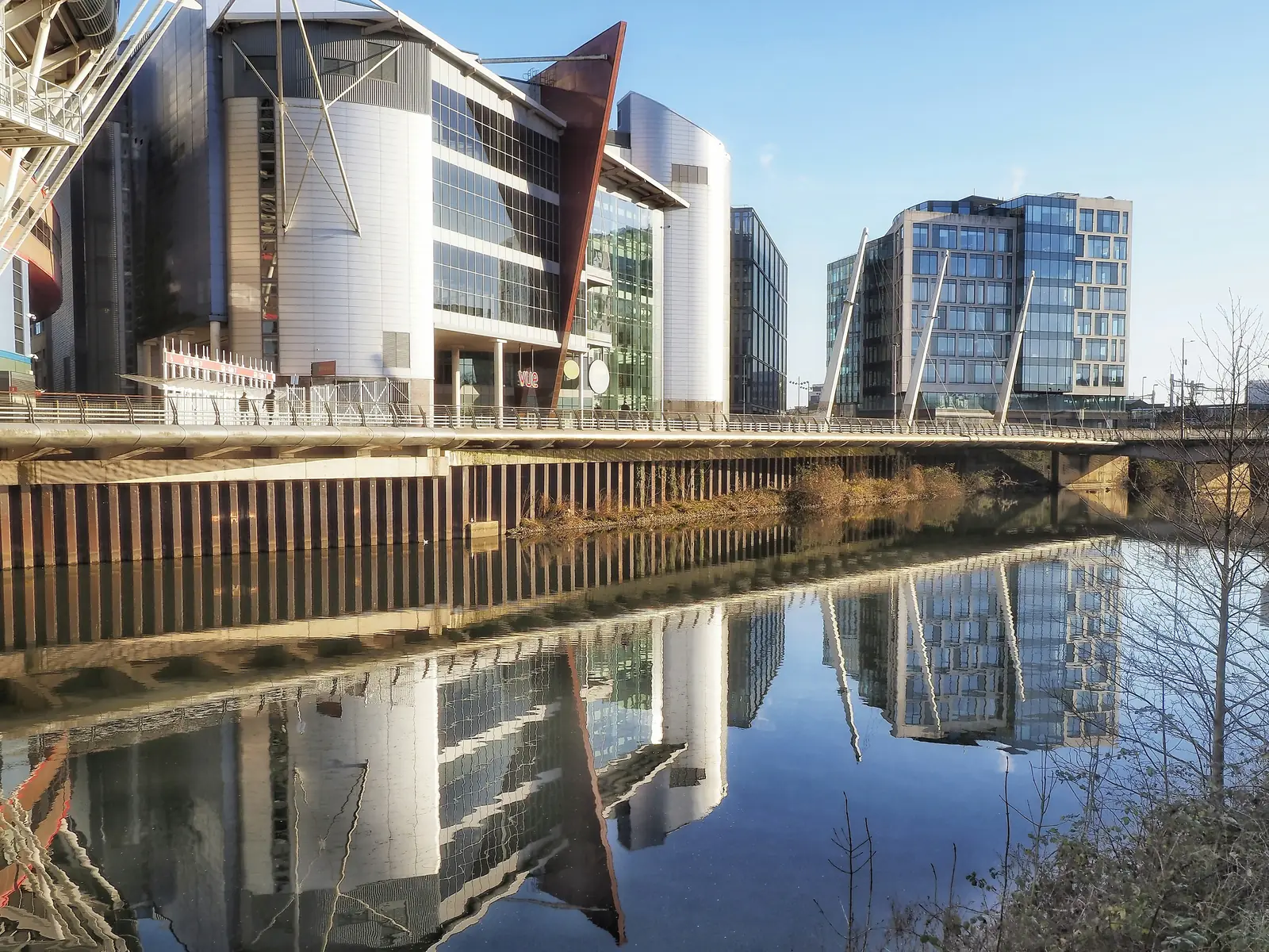 Modern buildings reflected in the water at Cardiff Bay