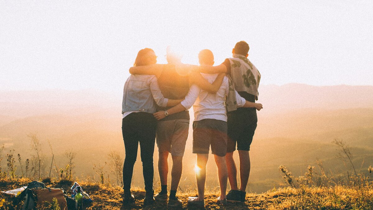 Team celebrating together at sunset