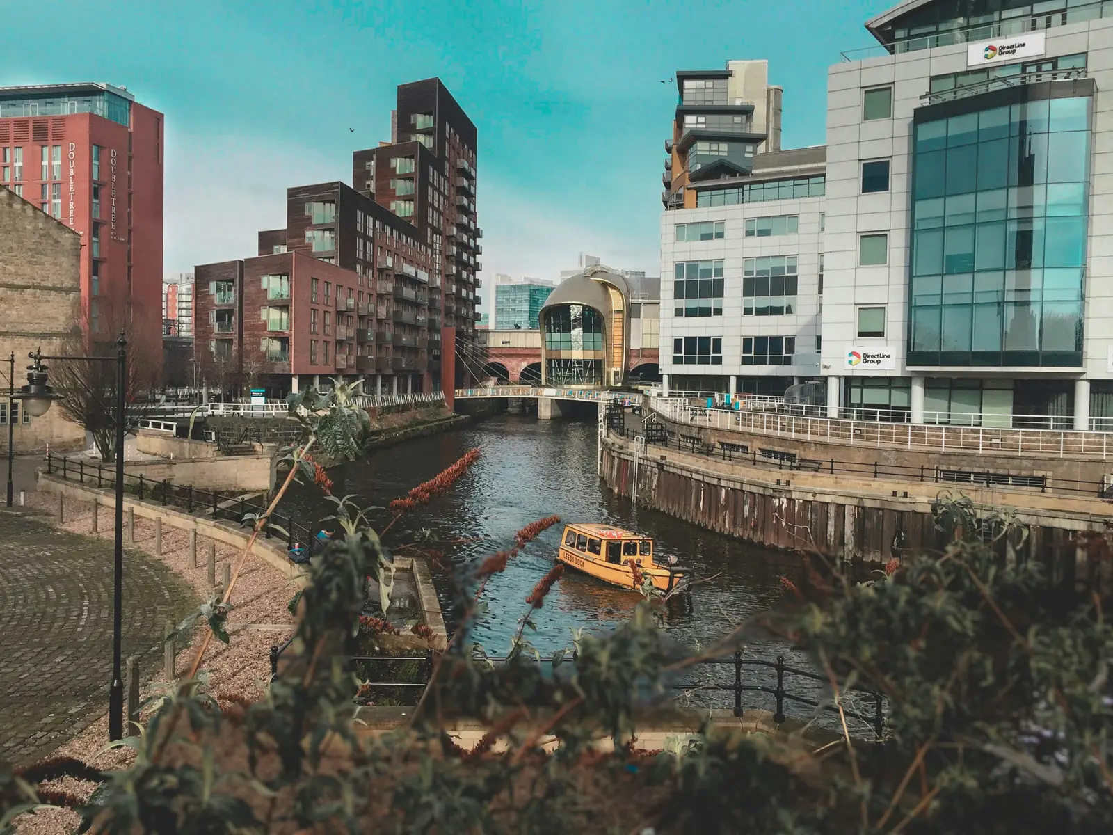 Modern buildings and a water taxi on the Leeds waterfront