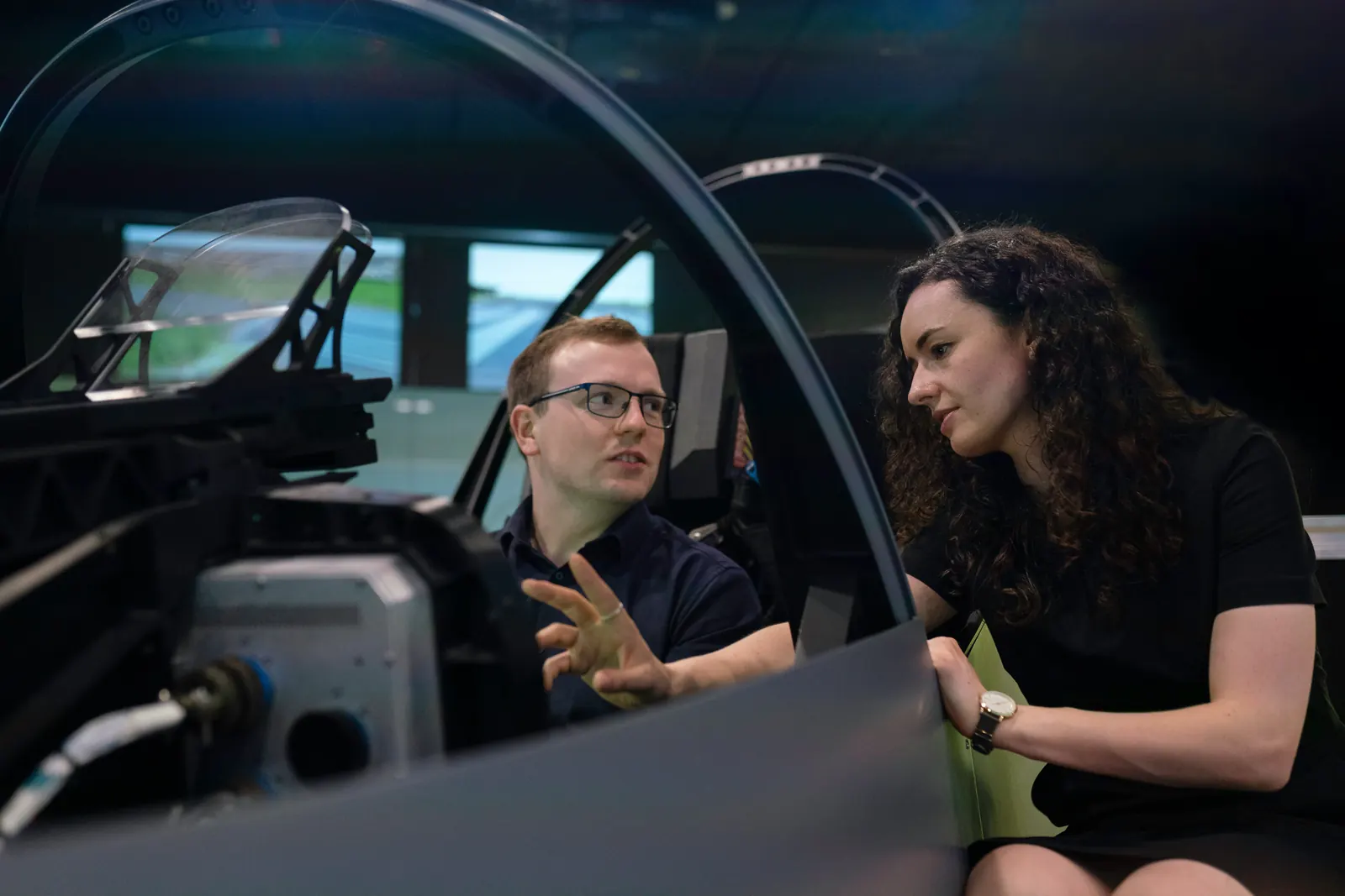 Two engineers developing and reviewing a vehicle simulator
